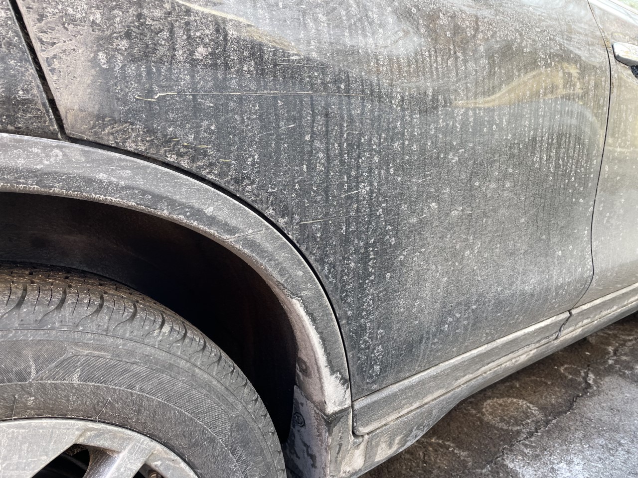 Dried salt crust coating a car's lower panel and wheel arch